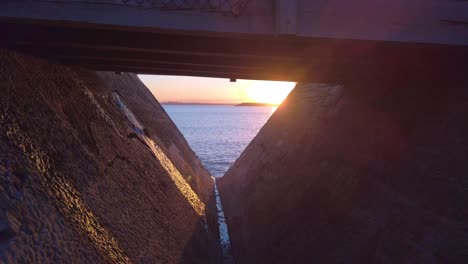 Tilting-up-shot-revealing-a-beautiful-sunset-and-sunrise-from-under-a-bridge