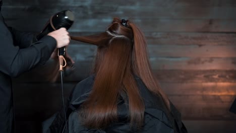 drying long hair with a hair dryer in the beauty salon woman professional hairdresser dries hair with a hairdryer - 120fps slow motion