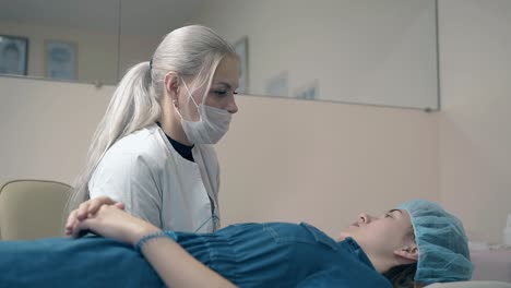 woman lies on couch and talks with brow master in salon