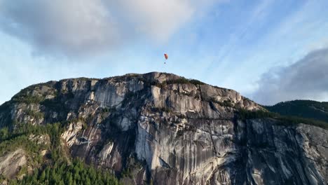 person paragliding over mountainous landscape of stawamus chief in british columbia, canada