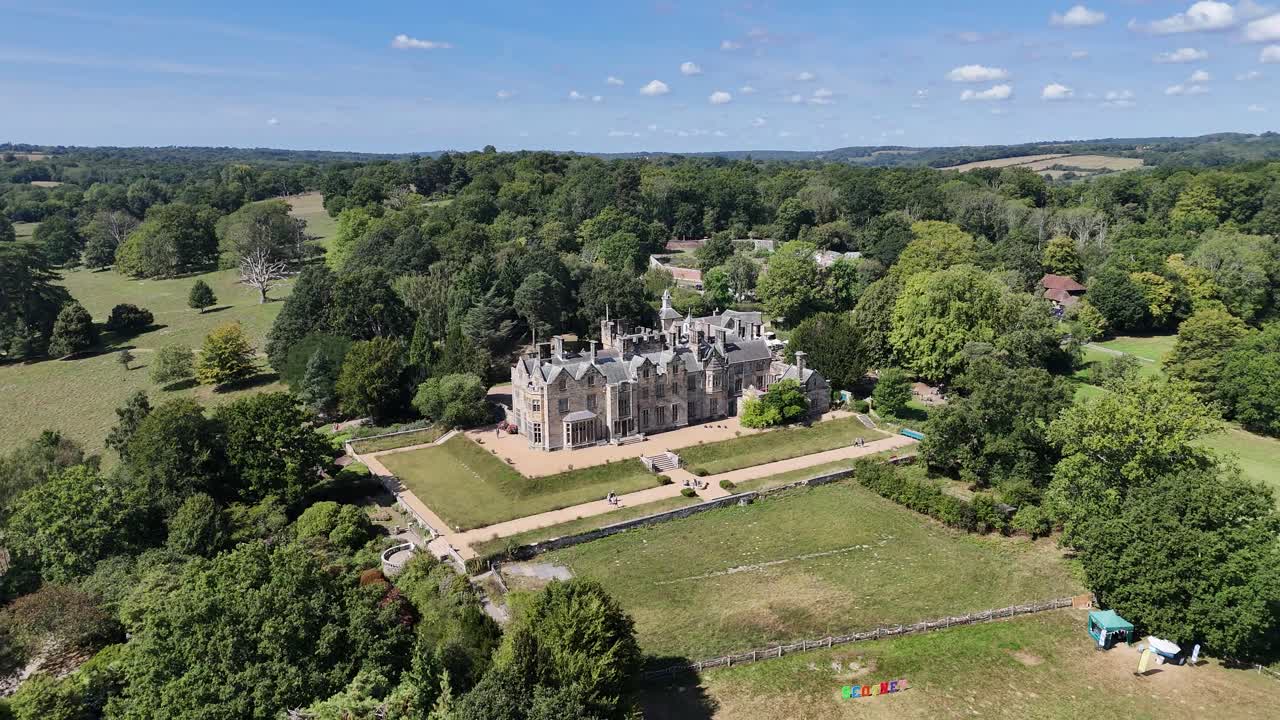 Majestic aerial view of Scotney’s Victorian mansion in Kent, England. Historic architecture framed by lush countryside, captured in cinematic drone footage for heritage and travel projects