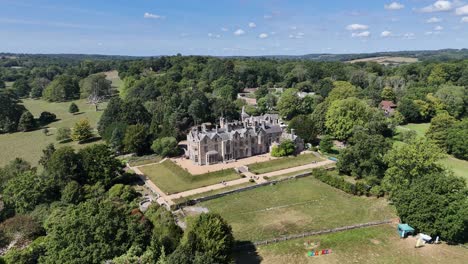 majestic aerial view of scotney’s victorian mansion in kent, england. historic architecture framed by lush countryside, captured in cinematic drone footage for heritage and travel projects