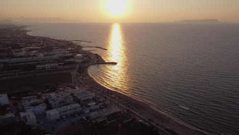 vibrant sunset reflected over the beach and resort in analipsi, crete island, greece