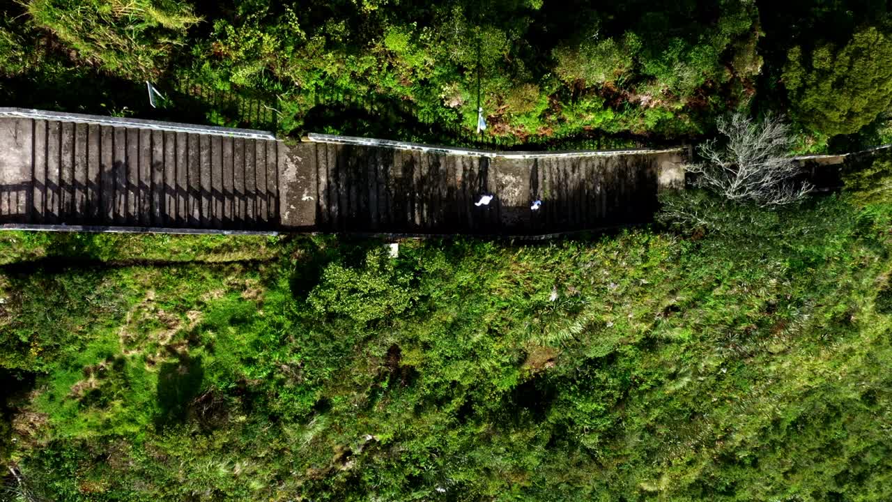 siguiendo a dos personas con largas sombras bajando los muchos escalones