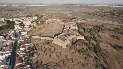 Hilltop-Castro-Marim-Castle,-fortress-overlooking-town-and-salt-plans