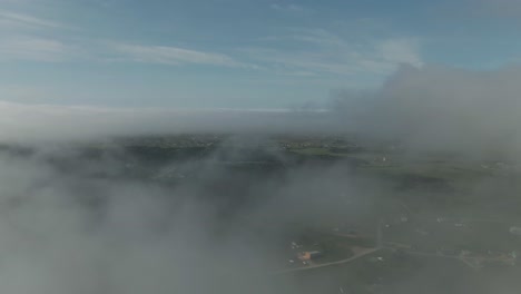 View-Of-The-Beautiful-Magdalen-Islands-In-Quebec,-Canada-Through-The-Moving-Clouds---aerial-drone