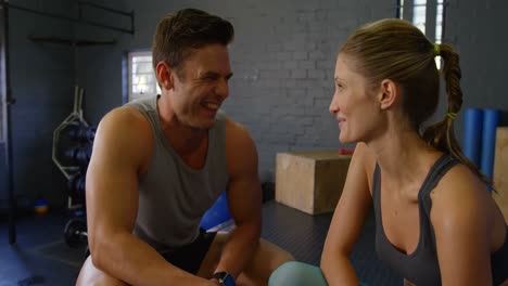 man and woman posing together in gym