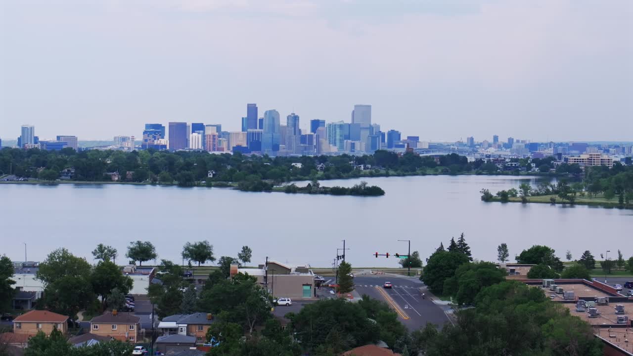 Summer downtown Denver Sloans Lake Park spring summer Colorado aerial drone parallax upwards blue skies clouds cityscape skyscrapers neighborhood business Coflax Sherdian cars traffic