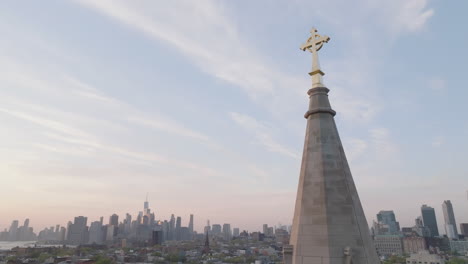 aerial view of a crucifix on top of a church steeple in new york city