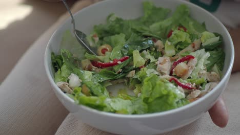 person eating a caesar salad