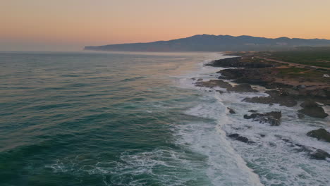 calm marine sunset aerial view. breathtaking golden sky over beautiful coastline