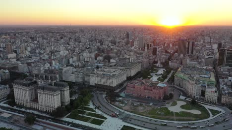 Cinematic-aerial-panoramic-view-of-the-big-and-urban-city-of-Buenos-Aires-at-sunset,-Argentina