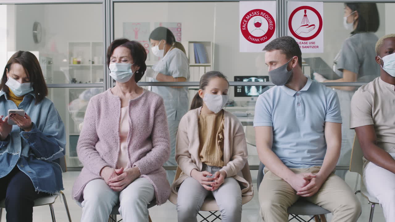 Diverse People In Masks Waiting In Hospital Queue