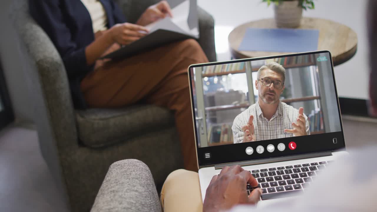 Animation of african american man having video call on laptop
