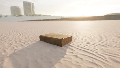 old book on the sand beach