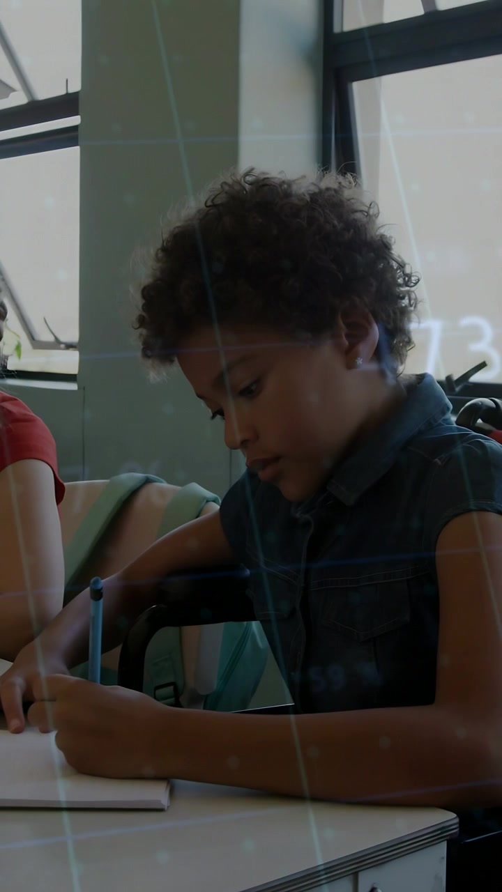 Vertical video: Child writing notebook for class camera pulling back green graph moving across page
