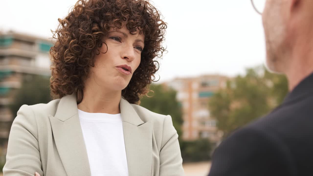 Female executive talking with coworker in city