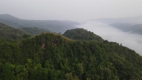 aerial view, tropical forests and visible white clouds blanketing forests in indonesia
