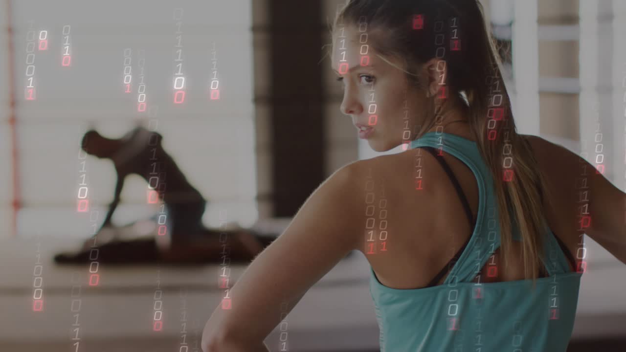 Female athlete observing digital code overlay falling while partner adjusting gear for fitness data