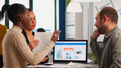 diverse company staff group talking sitting at desk in modern office
