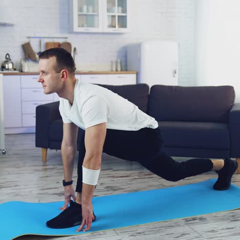man doing workout at home. young man exercising on a mat on floor during quarantine. fitness at home. healthy lifestyle