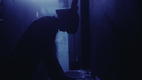 silhouette of a person in a dark bathroom