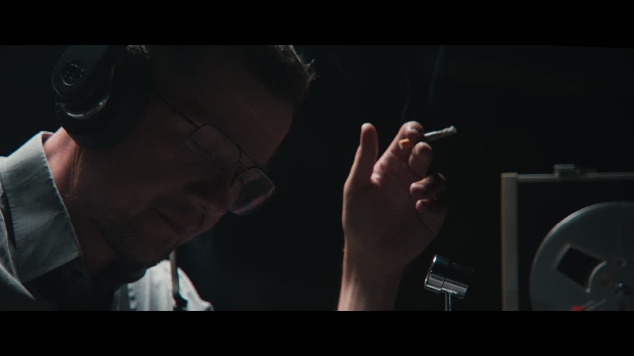 An intelligence officer listens to the wiretap recordings