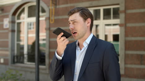 Close-up-view-of-businessman-talking-on-the-phone-outdoor