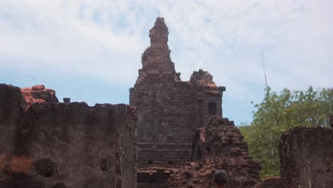 Woman-in-yellow-dress-admires-ancient-ruins-on-a-sunny-day