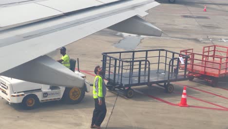 shot of pakistani ground staff handling the operations on runaway in pakistan.