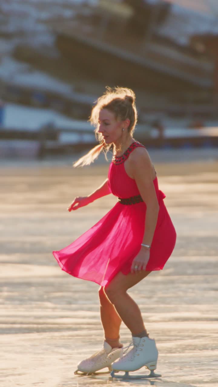 A graceful figure skater enchants the audience with her elegant movements on the ice, showcasing her talent and poise while wearing a stunning red dress that complements her ice skating performance beautifully