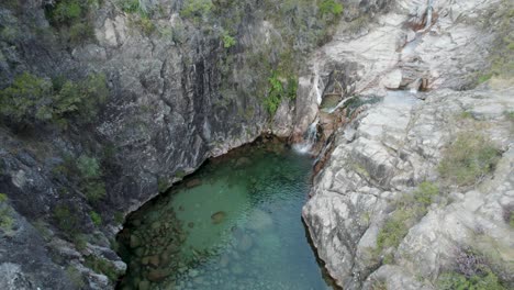 aerial tilt down over waterfall portela do homem