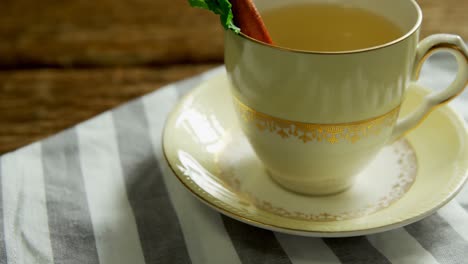 Herbal-tea-with-cinnamon-sticks-and-herb-on-a-cloth-4k