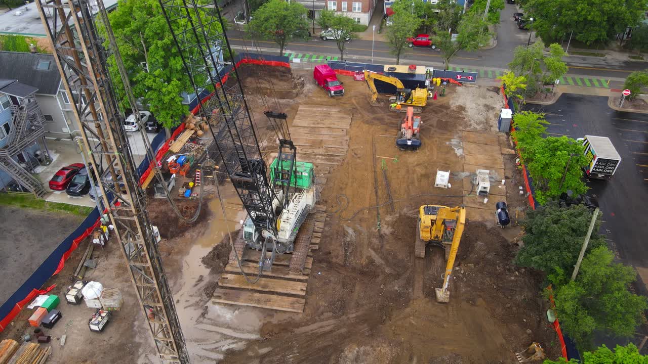 Aerial View of Construction Site with Heavy Machinery and Workers