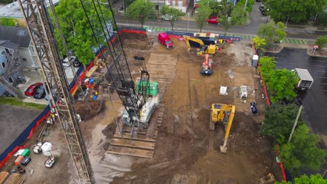 aerial view of construction site with heavy machinery and workers