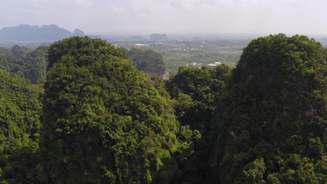 areal shot of the jungle covered limestone mountain formations near ao nang krabi thailand