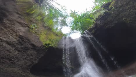 suwat waterfall cascades in the rainforest near ubud in bali, indonesia