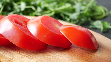 close-up of sliced tomatoes on wooden cutting board