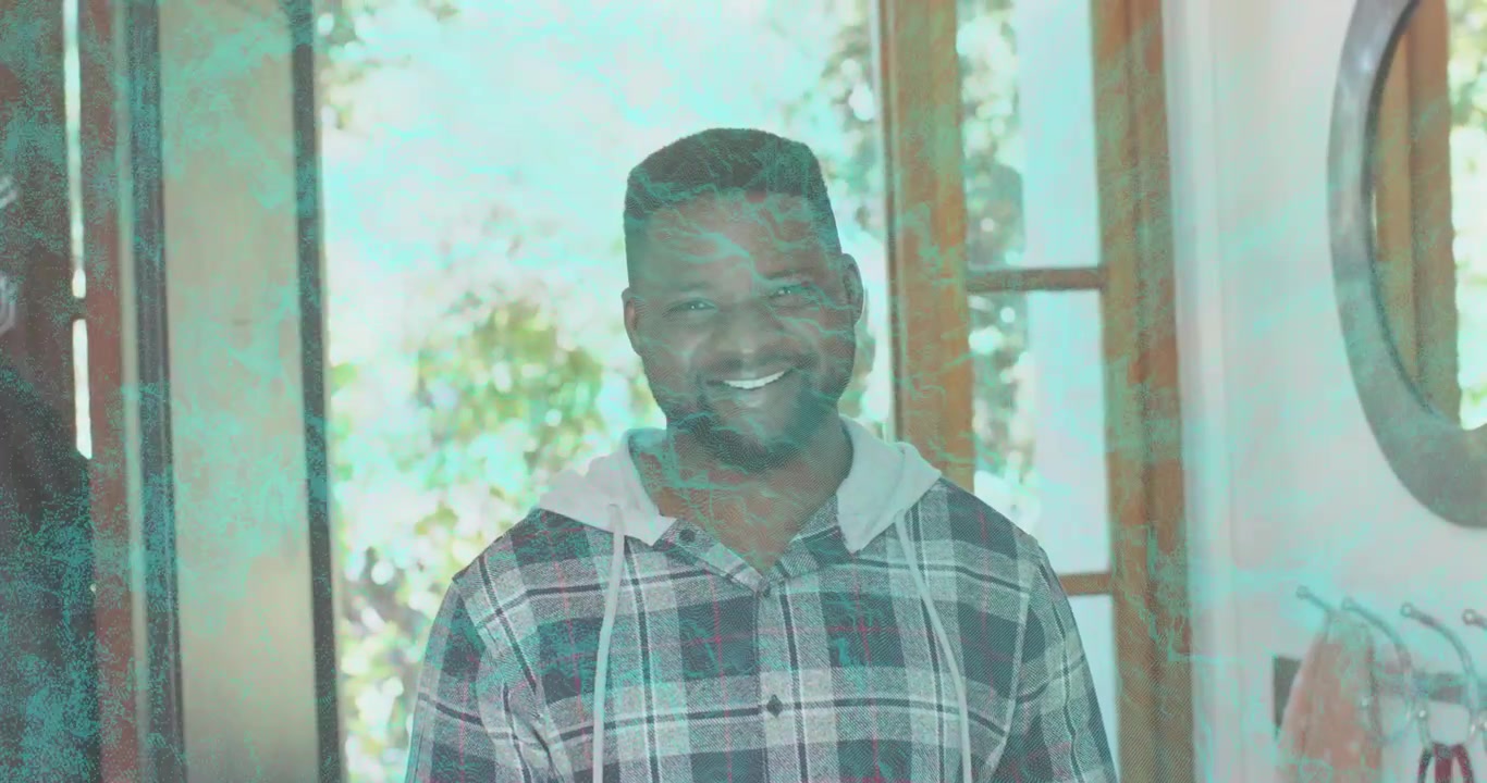mid-adult man standing smiling at foyer presence causing color overlay flickering for real estate