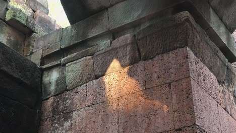 close tilt shot of old and renovated stones in a column in an ancient temple near angkor wat
