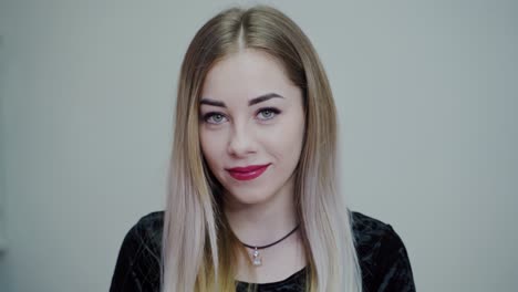 Portrait of beautiful young woman. Smiling girl with perfect make-up looking at camera. Happy face of attractive female. Close-up.