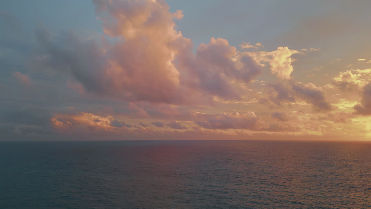 Sunset over the ocean with clouds