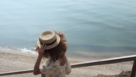 Cute-woman-running-downstairs-beautiful-beach.-Happy-girl-hurreing-to-sand-beach