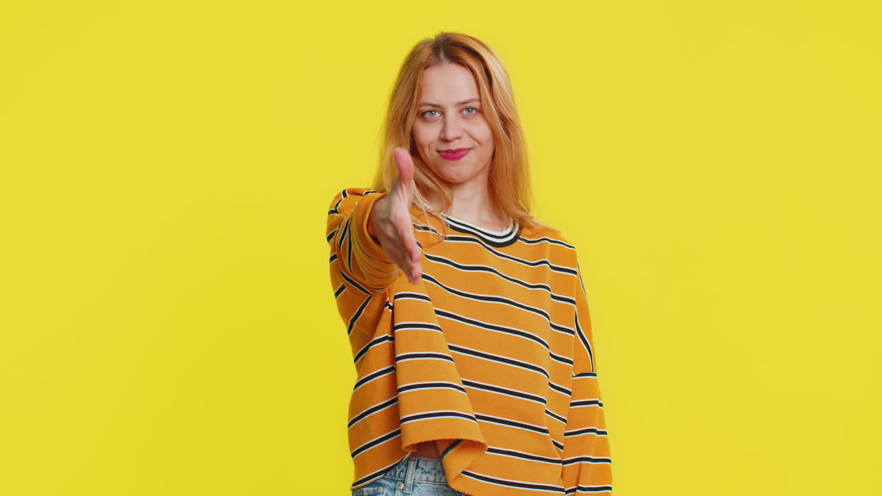 Caucasian woman outstretching hand to camera offering handshake greeting invitation welcoming