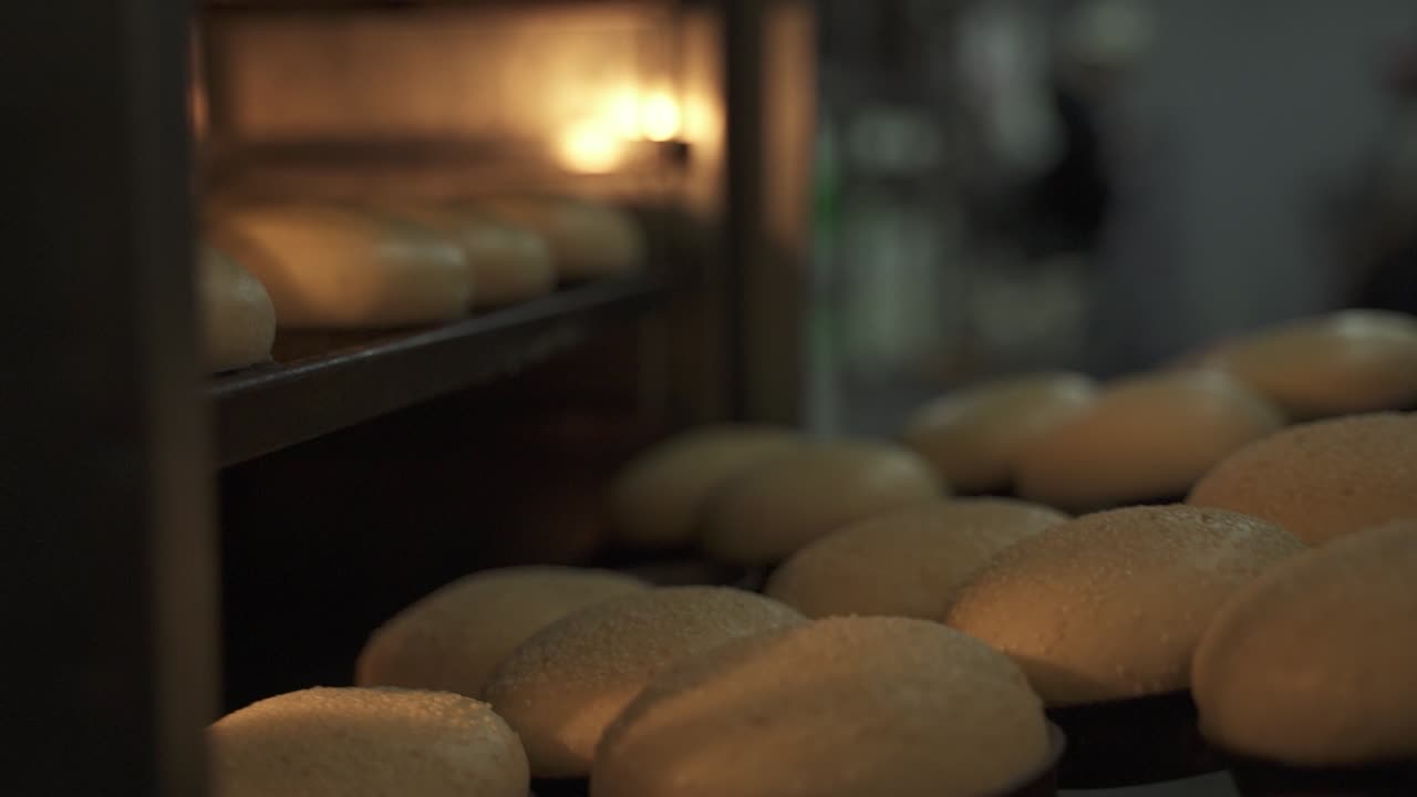 Slow motion di una teglia di pane che viene posizionata all'interno di un forno per la cottura