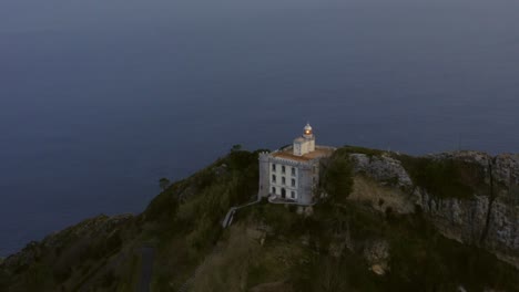 Aerial-slow-motion-orbit-around-'El-Faro-de-la-Plata'-lighthouse-on-a-cliff