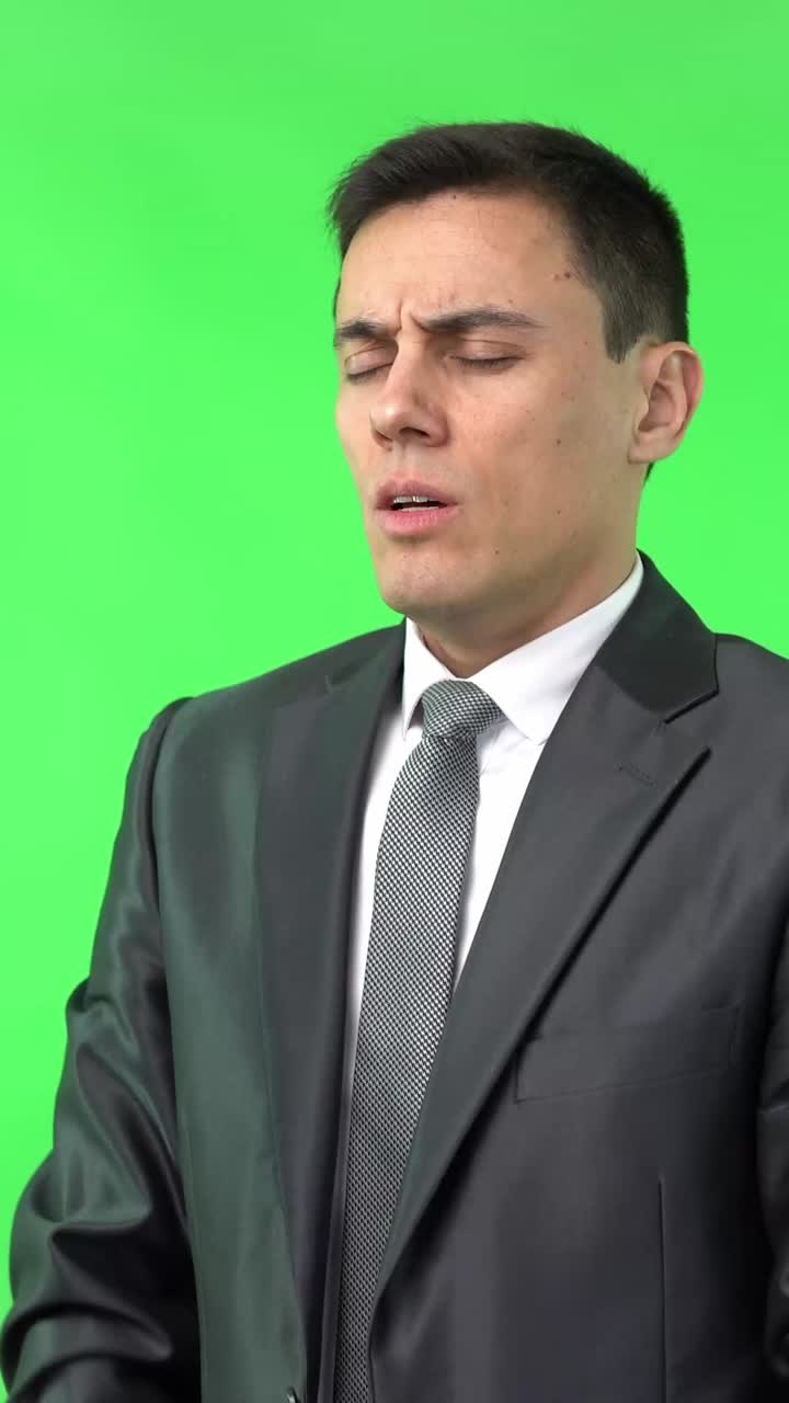 Man in Suit Praying or Concentrating on Green Screen