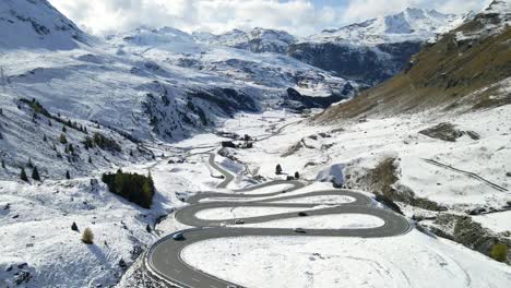 aerial view of the julierpass with a fresh snow layout and the snowy alps in the horizon in switzerland.