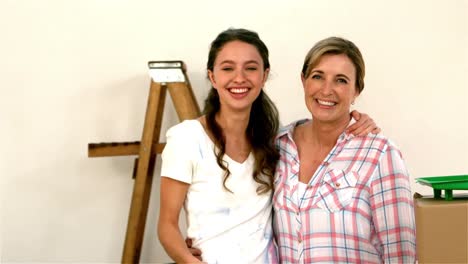 Mother-and-daughter-smiling-and-showing-their-brushes-at-the-camera