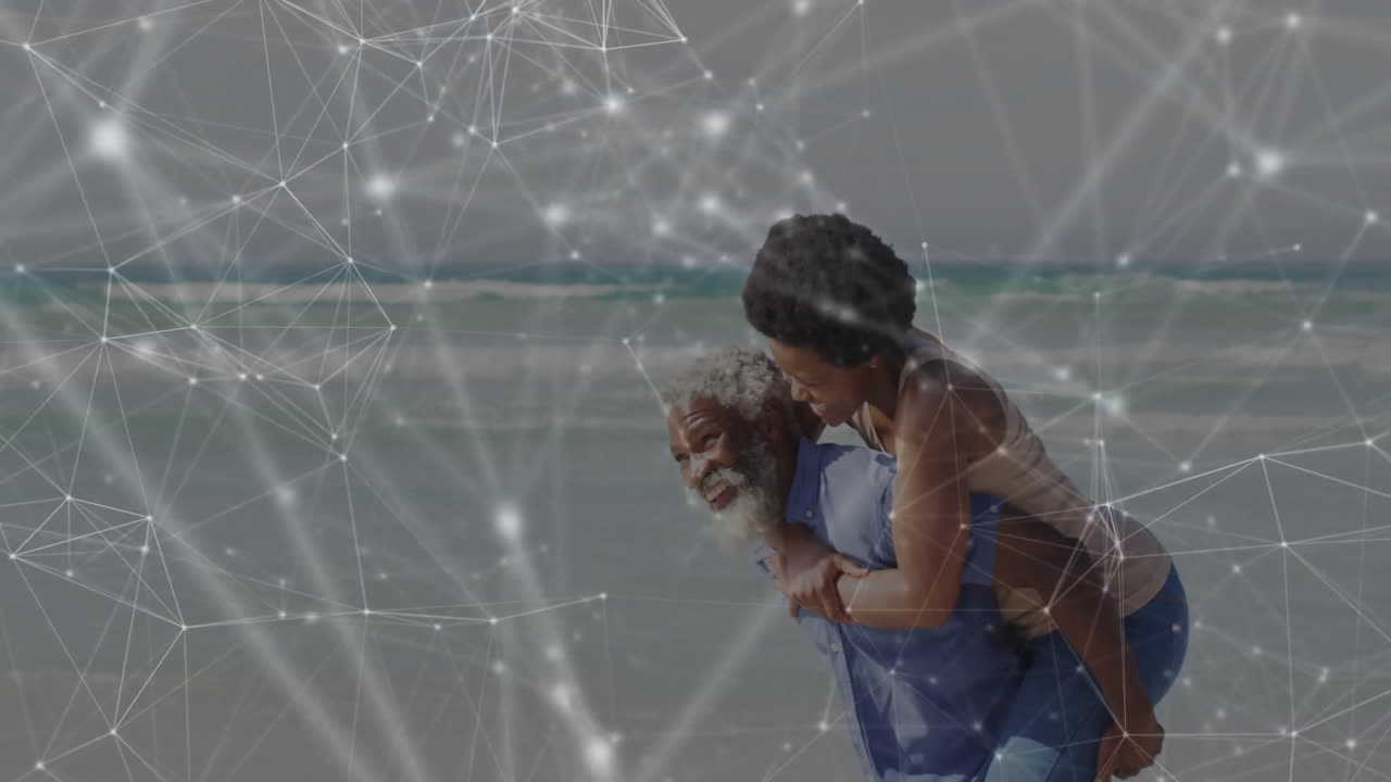 Father giving piggyback ride on sandy beach, daughter smiling under glowing tech network overlay